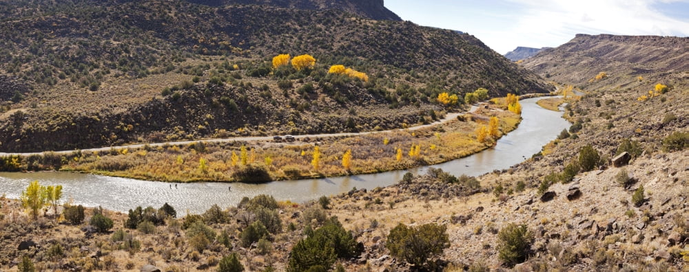 Elevated view of three men fishing in the river Rio Grande Taos Taos County New Mexico USA Canvas Art - Panoramic Images (27 x 9)