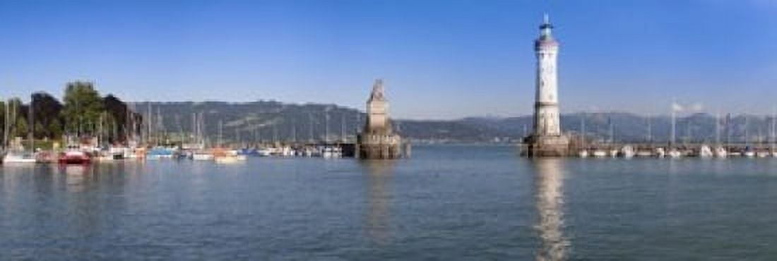 Entrance of the harbor with the Bavarian lion and the lighthouse Lindau Lake Constance Bavaria Germany Canvas Art - Panoramic Images (18 x 6)