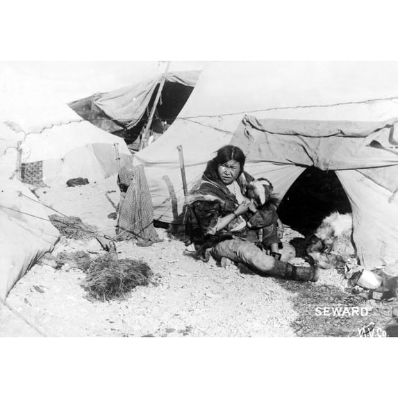 Eskimo Woman And Child. /Nan Eskimo Woman Sitting Outside A Tent Breast