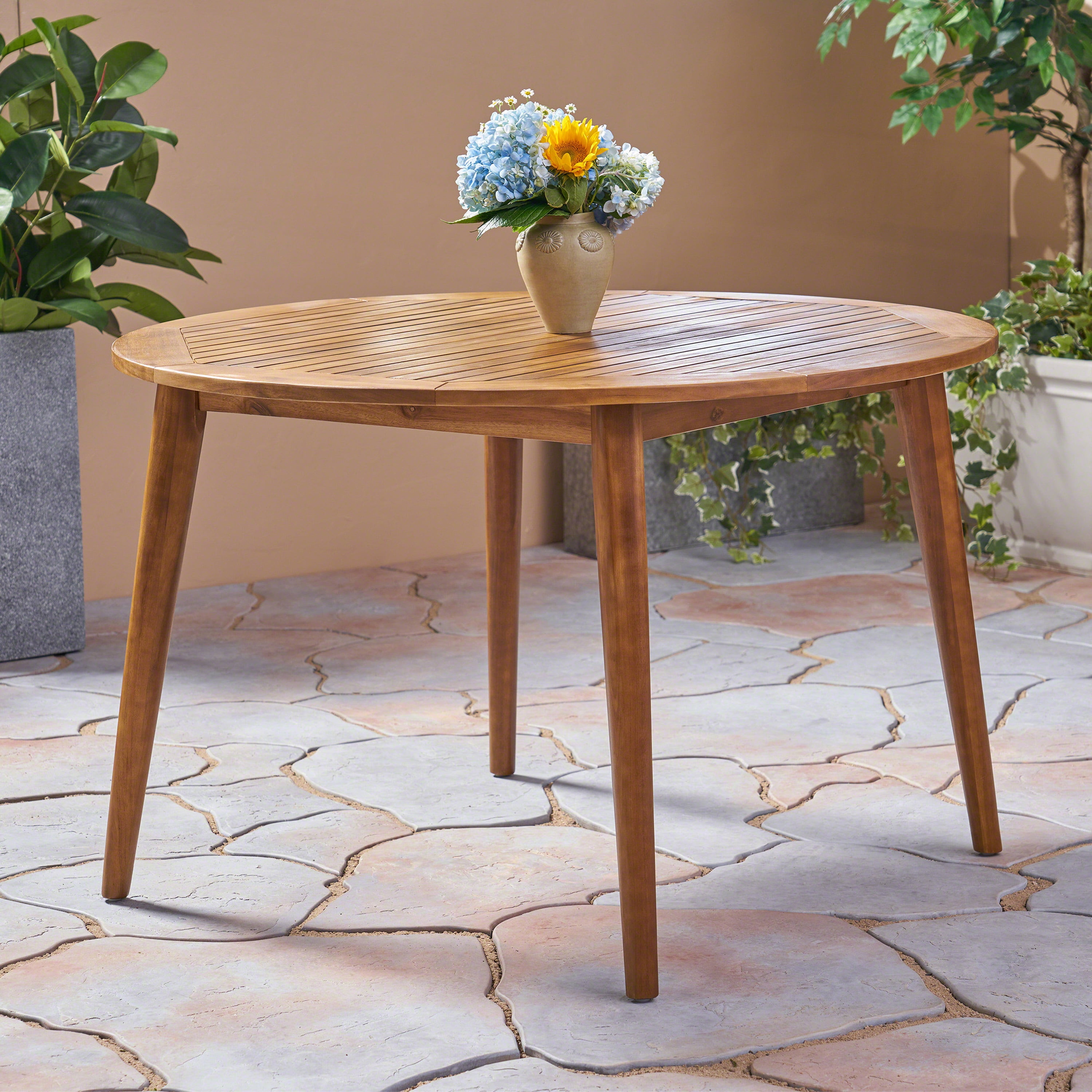 Euroco simple and sleek acacia wood dining table is the perfect addition to any backyard space