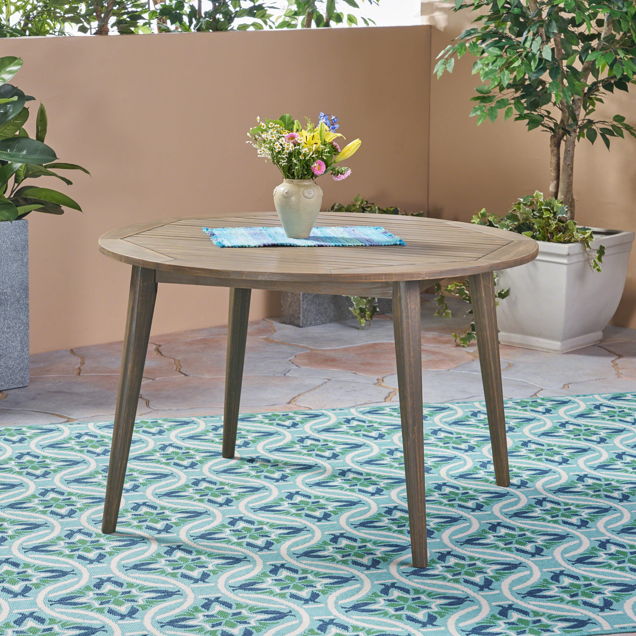 Euroco simple and sleek acacia wood dining table is the perfect addition to any backyard space