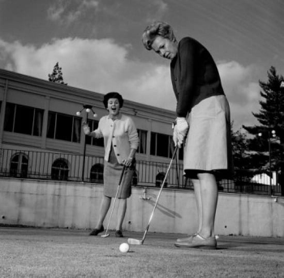 Excited woman watching while other is playing golf Canvas Art - (18 x 24)