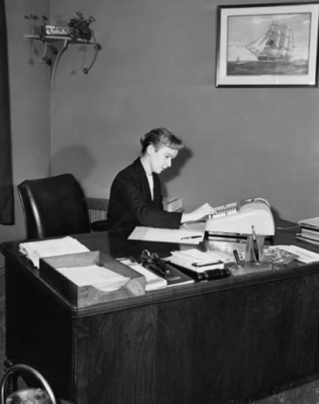 Executive accountant using an adding machine in an office Canvas Art - (18 x 24)