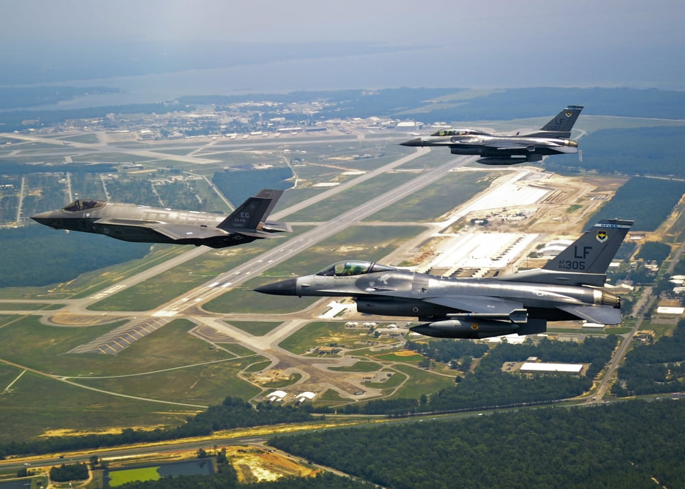 F-35 Lightning II aircraft in flight with two F-16 Fighting Falcons over Florida Canvas Art - Stocktrek Images (34 x 24)