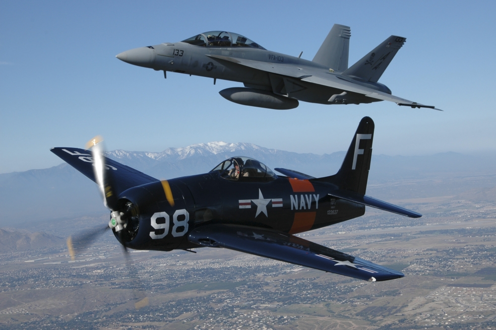 FA-18 Hornet and F8F Bearcat flying over Chino California Canvas Art - Phil WallickStocktrek Images (34 x 23)