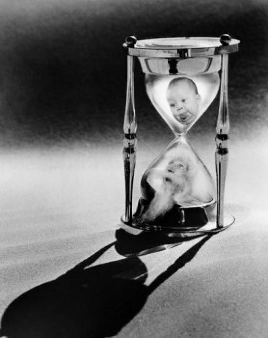 Faces of a baby boy and a senior man in an hourglass Canvas Art - (24 x 36)