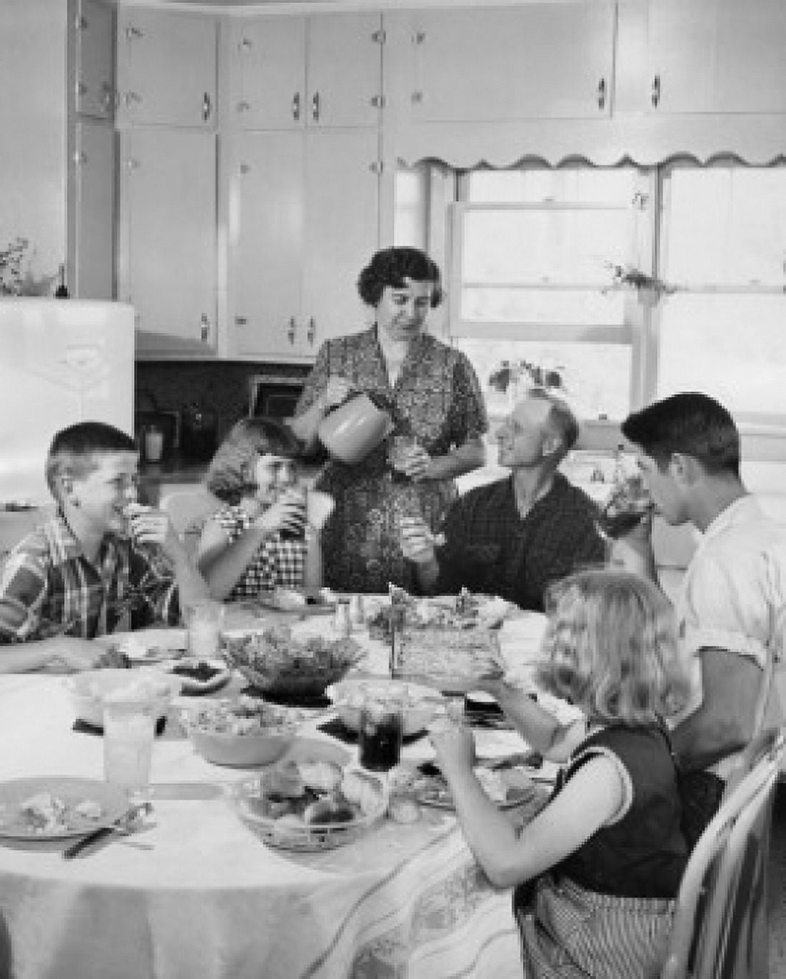 Family eating together in kitchen Canvas Art - (24 x 36)