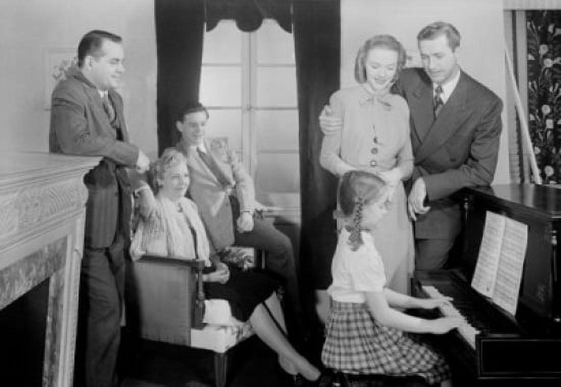Family listening as girl plays piano Canvas Art - (18 x 24)