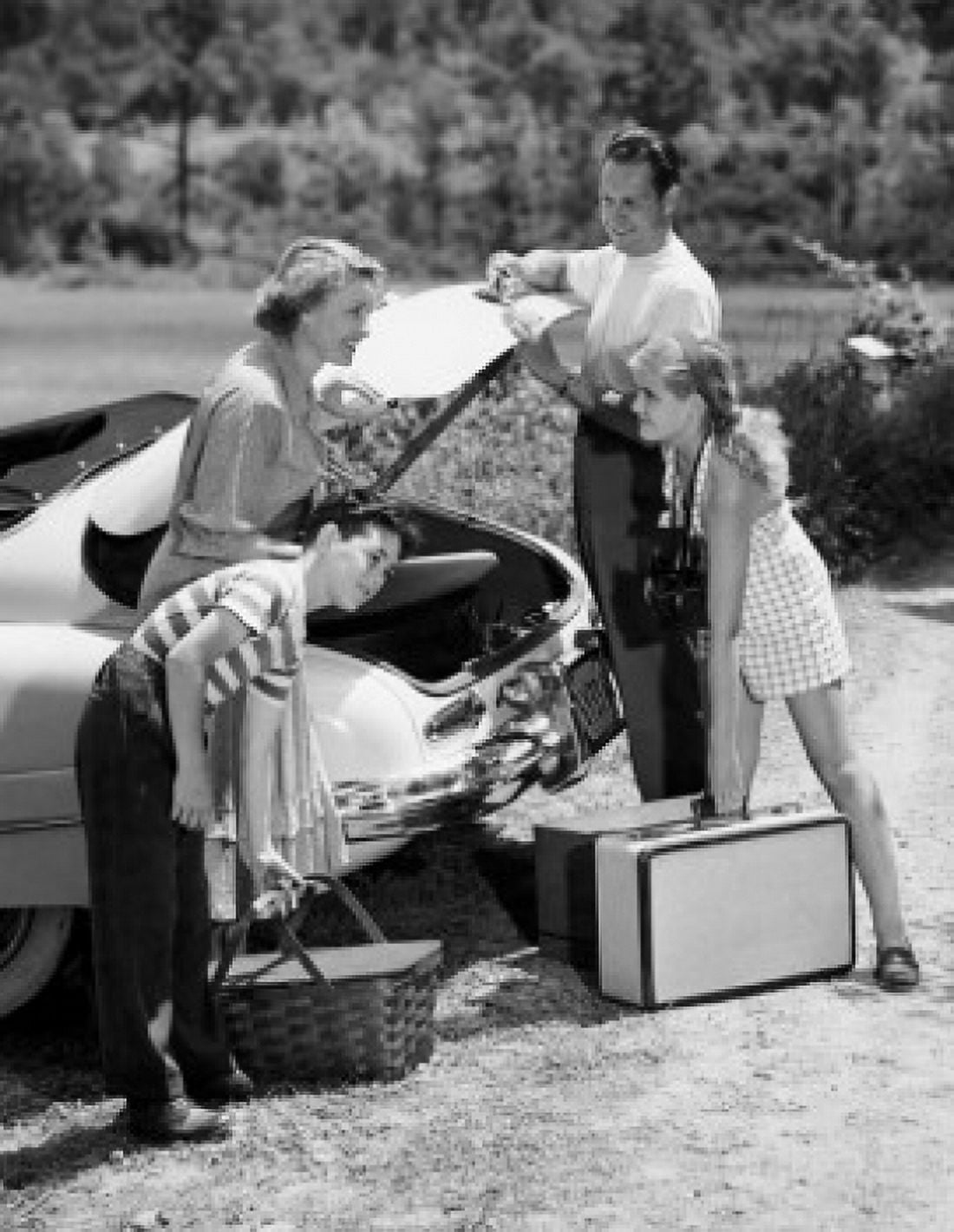 Family loading luggage into a car Canvas Art - (18 x 24)
