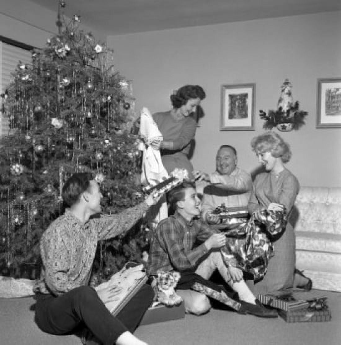Family opening christmas gifts around Christmas tree Canvas Art - (18 x 24)