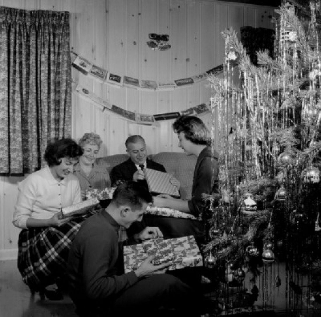 Family opening gifts by Christmas tree in living room Canvas Art -  (18 x 24)