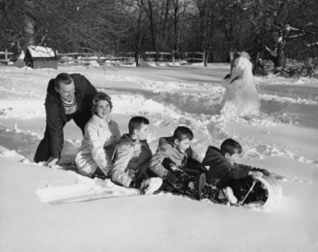 Family playing in the snow on a sled Canvas Art - (18 x 24)