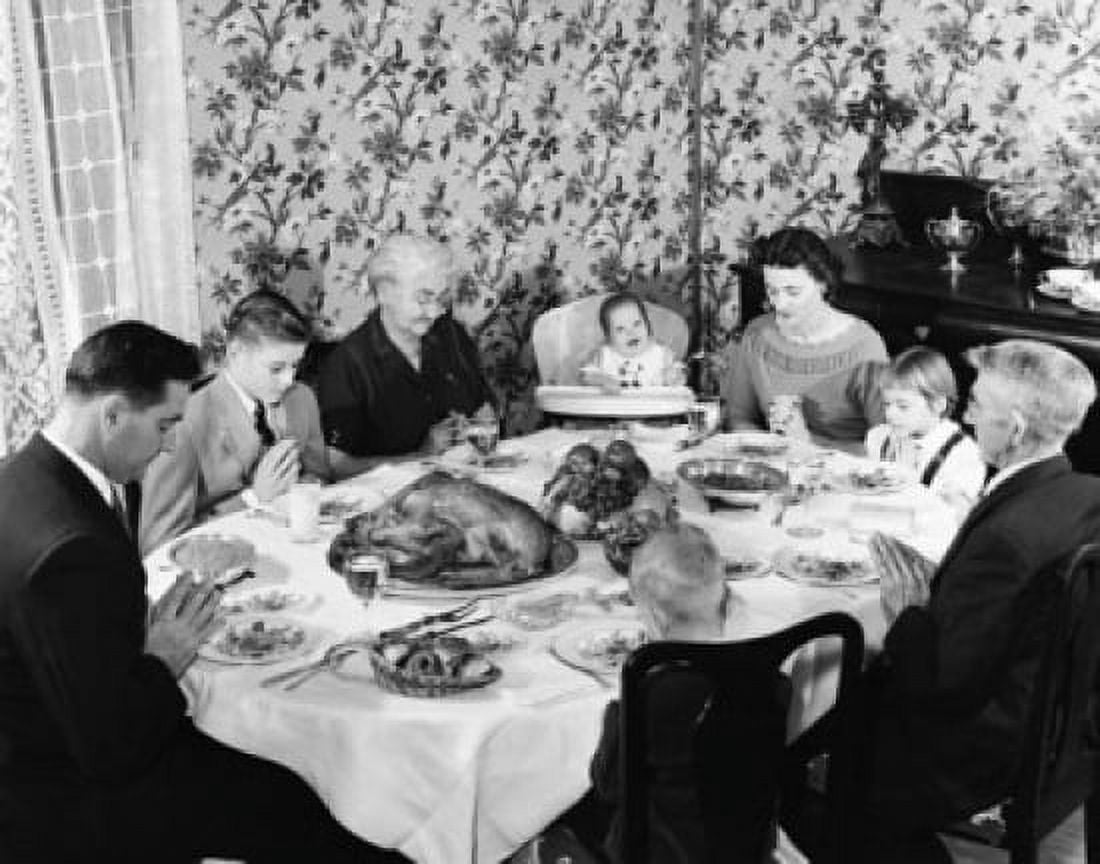 Family praying at dining table on Thanksgiving Day Canvas Art -  (18 x 24)