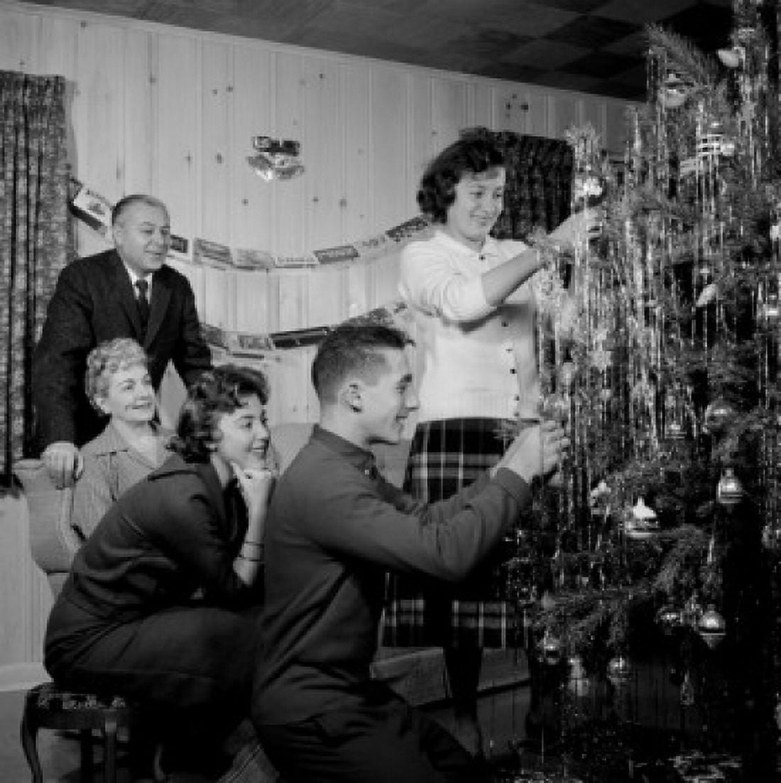 Family preparing Christmas tree in living room Canvas Art - (24 x 36)