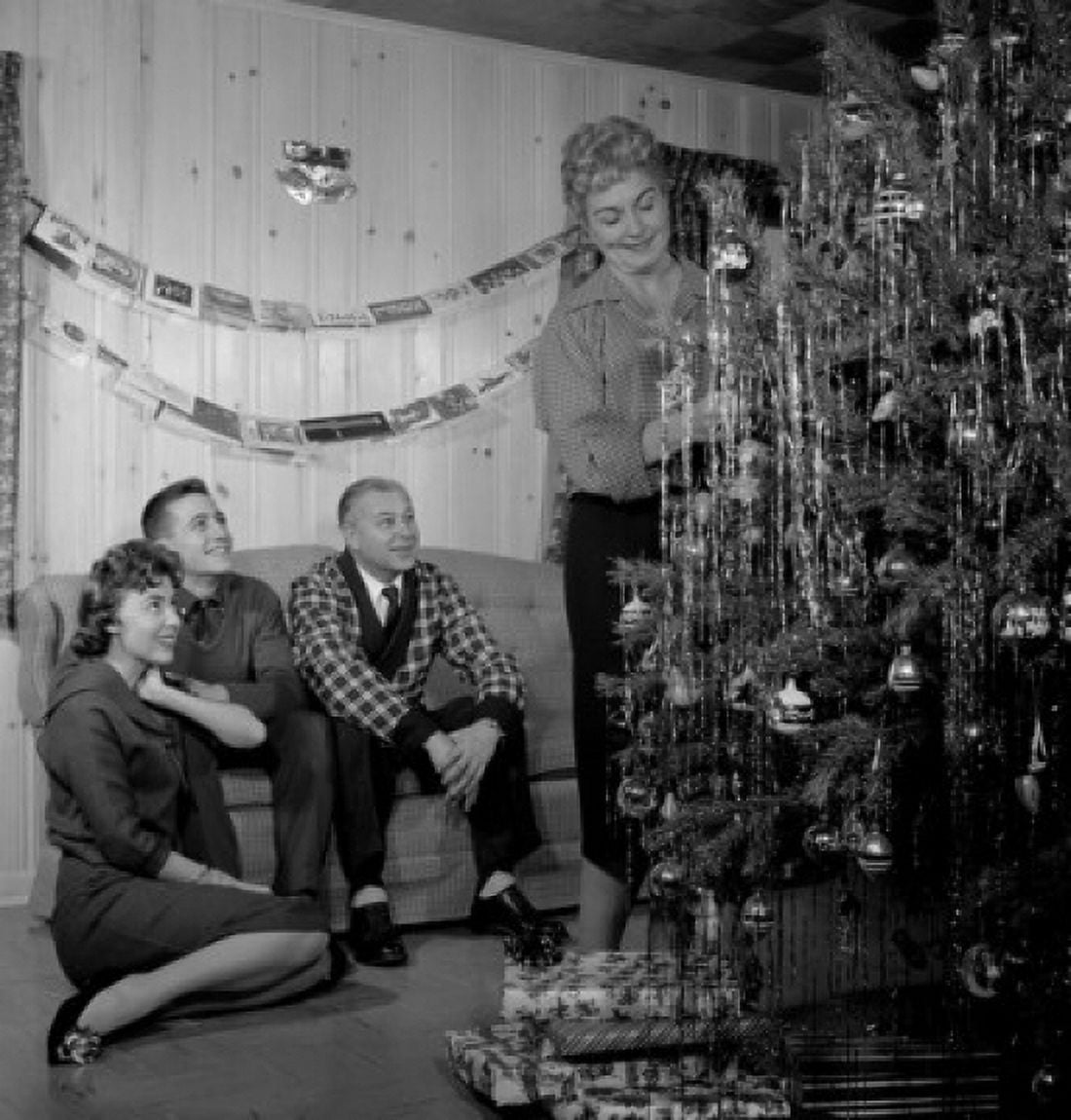 Family preparing Christmas tree in living room Canvas Art -  (24 x 36)