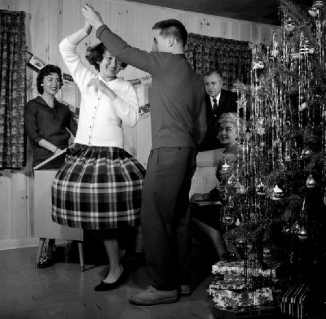 Family watching couple dancing by Christmas tree Canvas Art - (24 x 36)