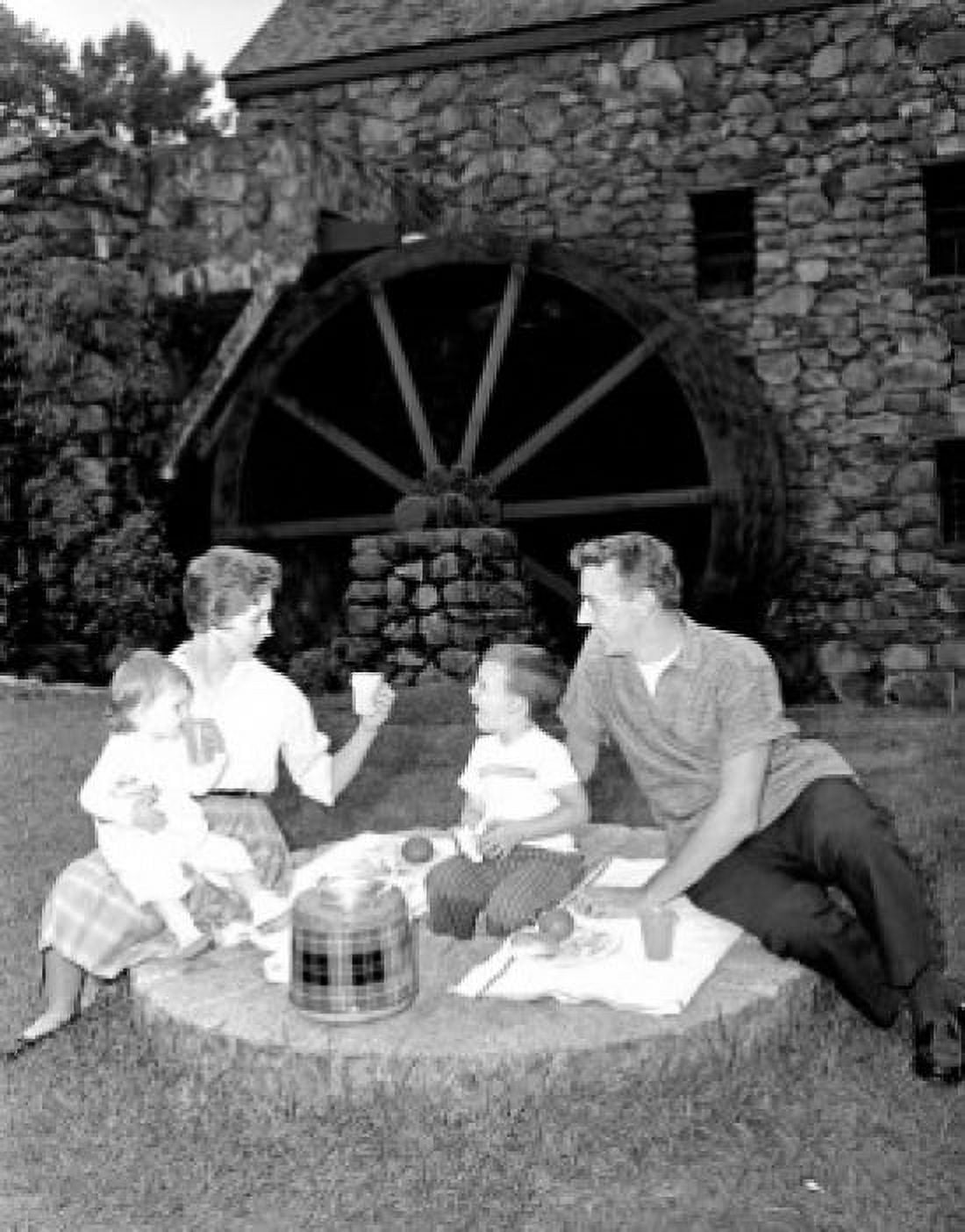 Family with baby girl and boy on picnic by water mill Canvas Art - (24 x 36)