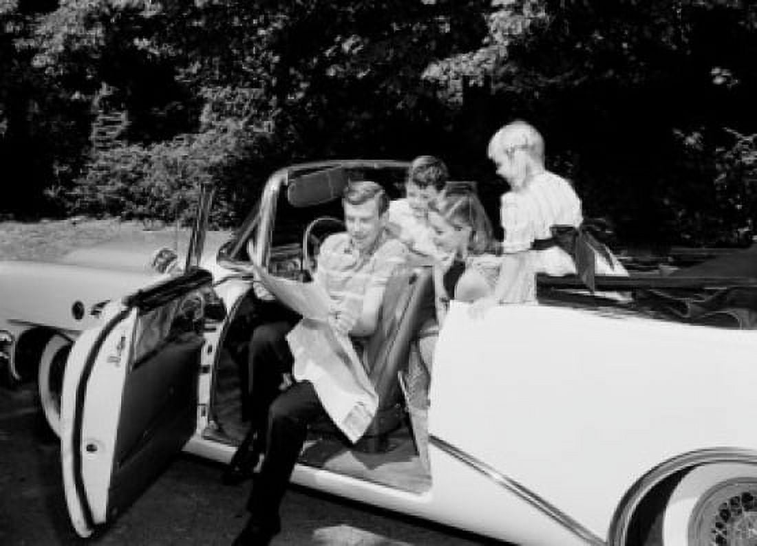 Family with boy and girl sitting in convertible car examining map Canvas Art - (24 x 36)