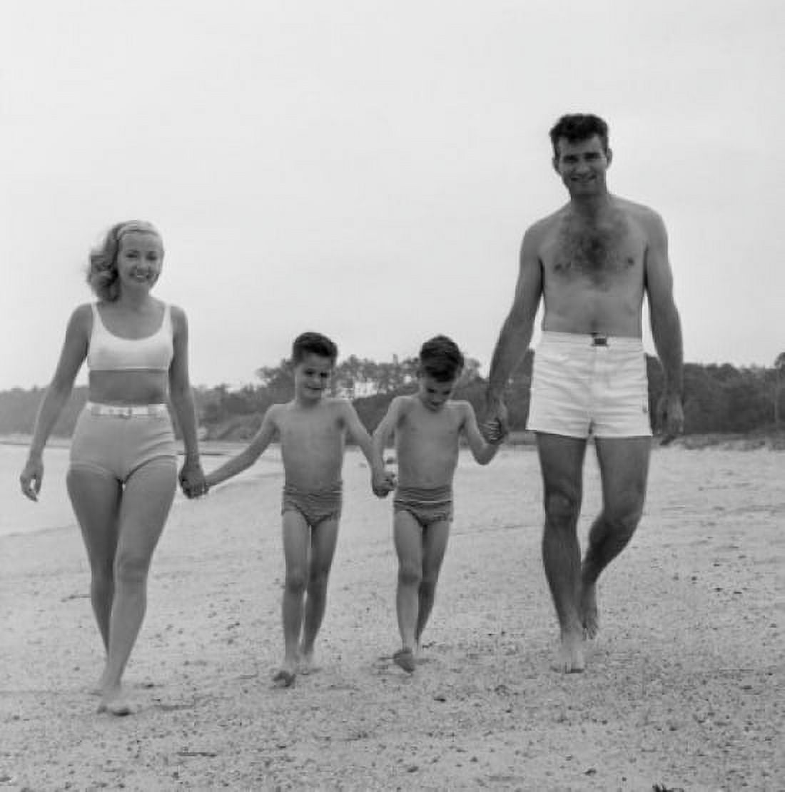 Family with two sons walking on beach Canvas Art - (18 x 24)