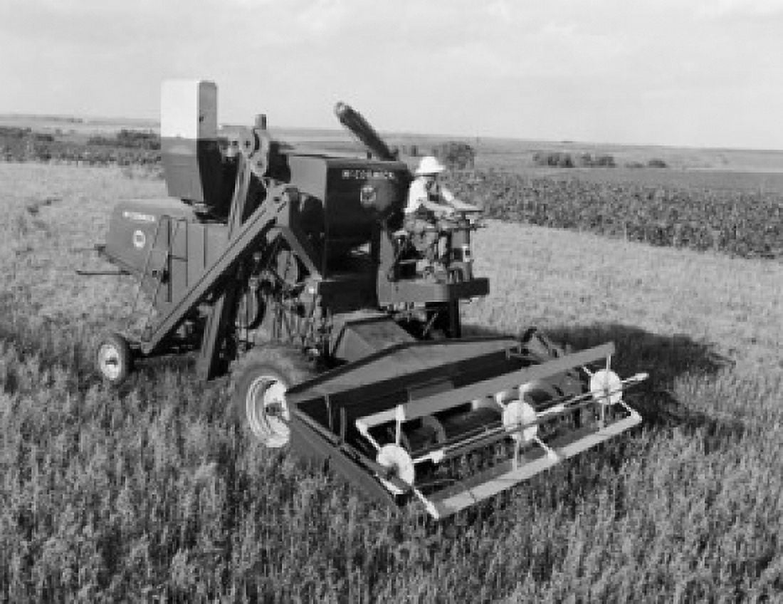 Farmer harvesting oats with a combine in a field Canvas Art - (24 x 36)