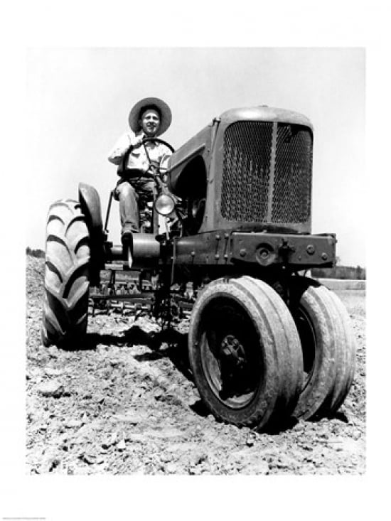 Farmer sitting on a tractor in a field Canvas Art - (18 x 24)
