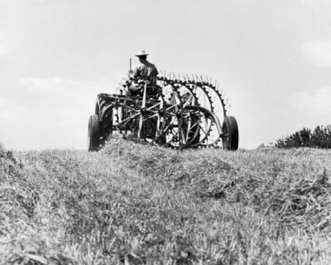 Farmer sitting on a tractor in a hay field Canvas Art - (24 x 36)