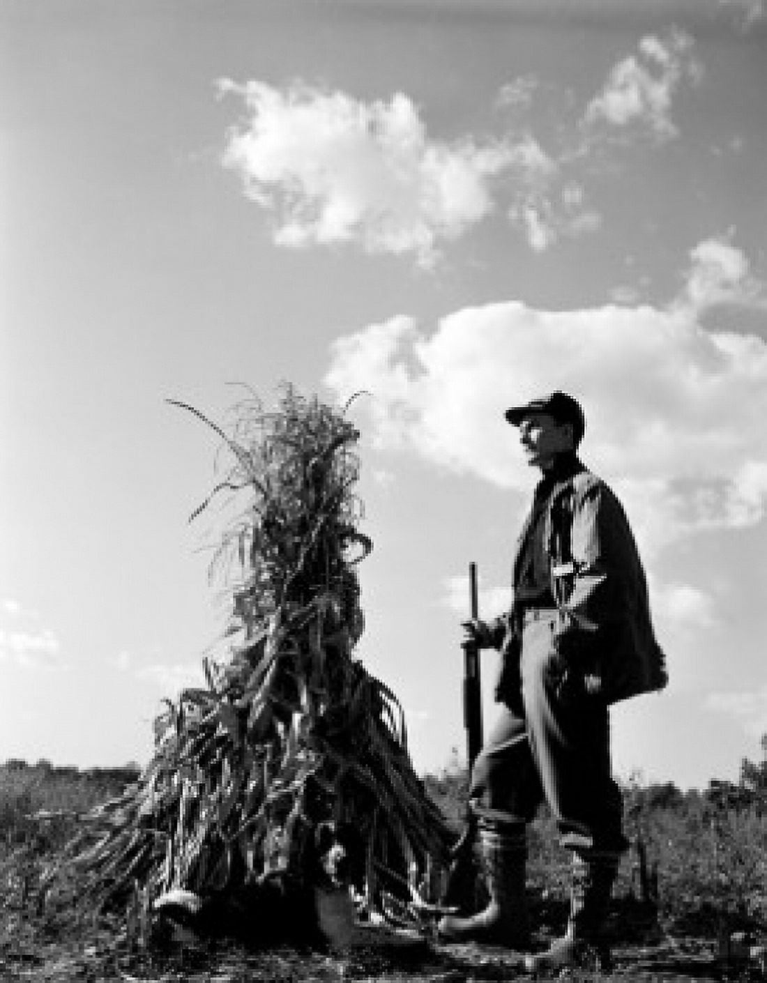 Farmer standing on field and holding gun Canvas Art - (18 x 24)