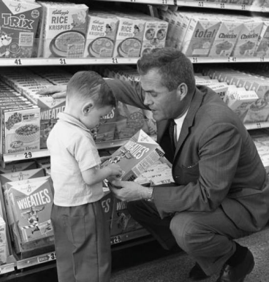 Father and son choosing cereal Canvas Art - (24 x 36)