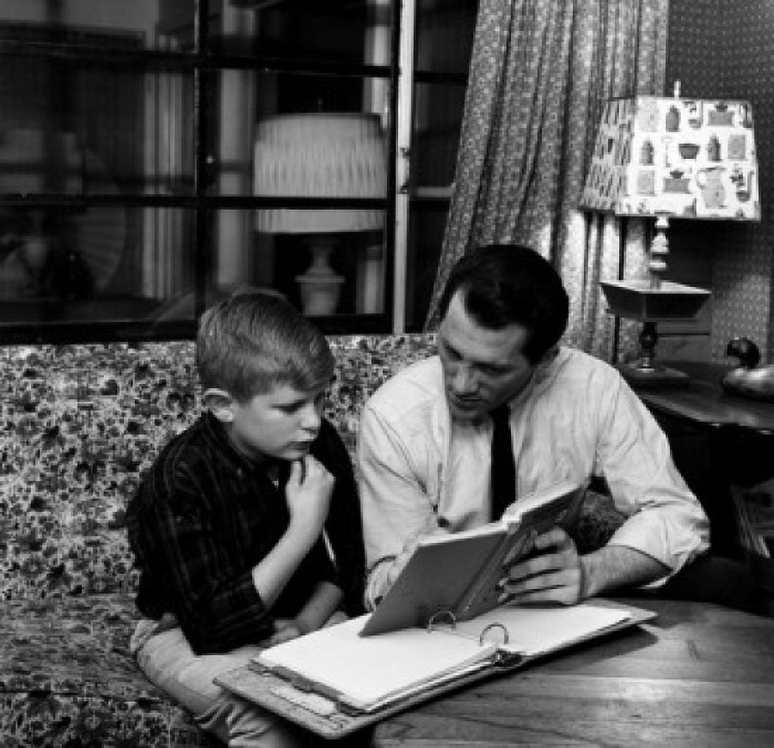 Father and son doing homework in living room Canvas Art - (18 x 24)