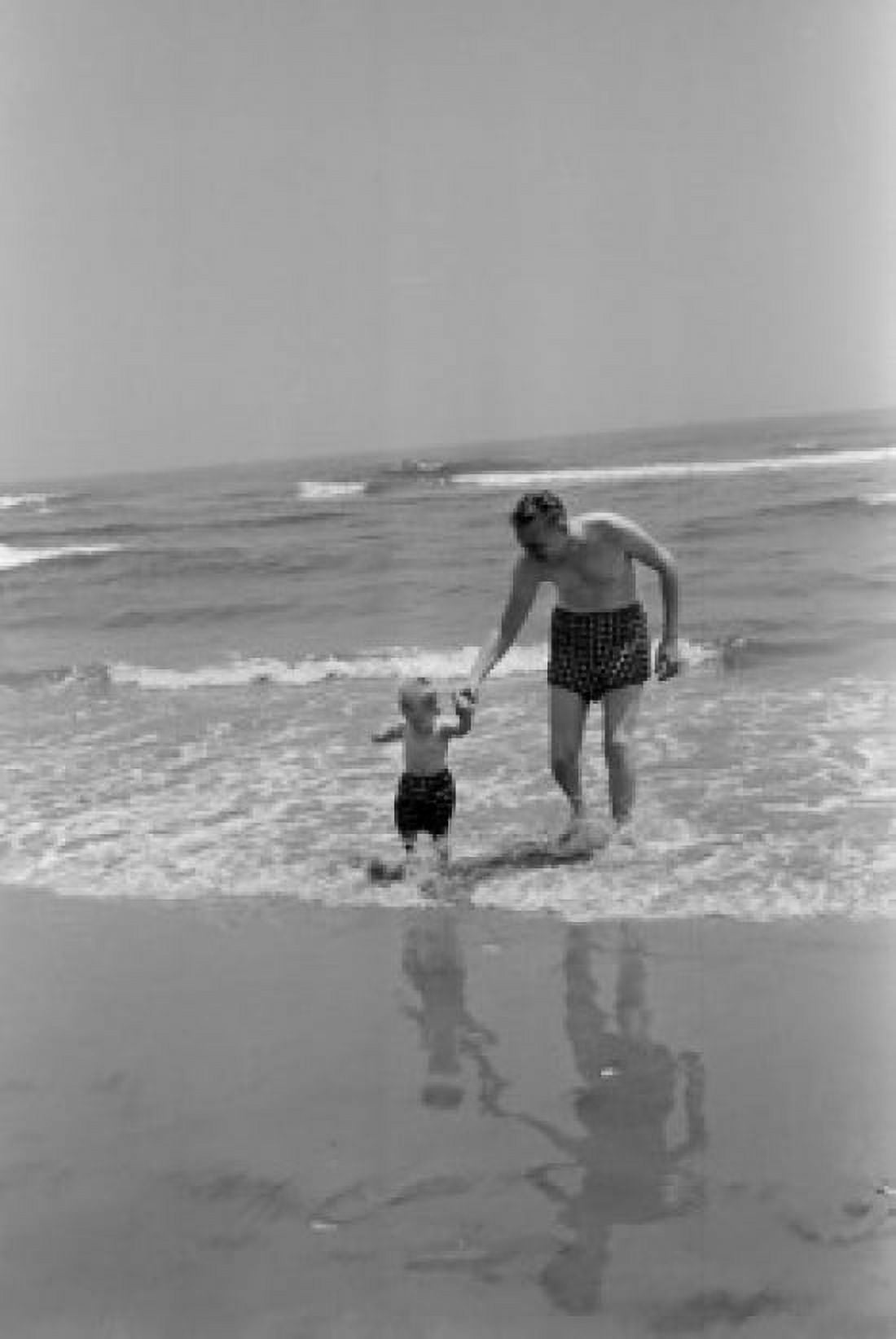 Father and son playing on beach Canvas Art - (24 x 36)