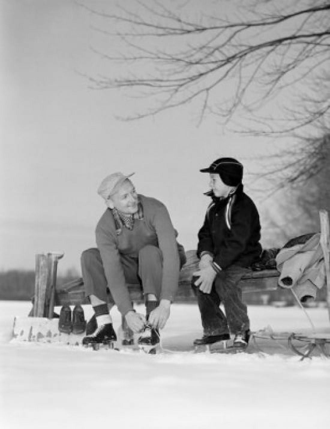 Father and son putting on ice skates Canvas Art - (18 x 24)