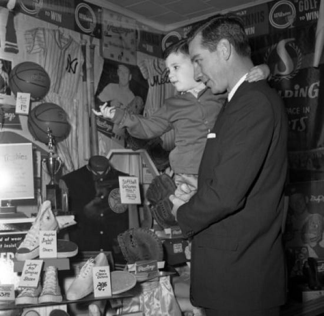 Father and son watching shoes in store Canvas Art - (24 x 36)