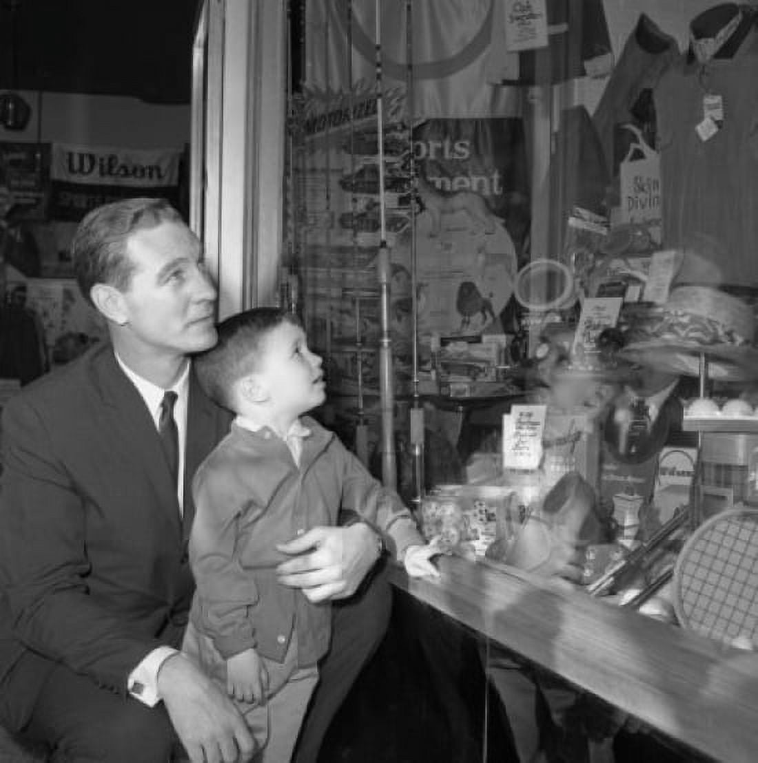 Father and son watching window display Canvas Art - (24 x 36)