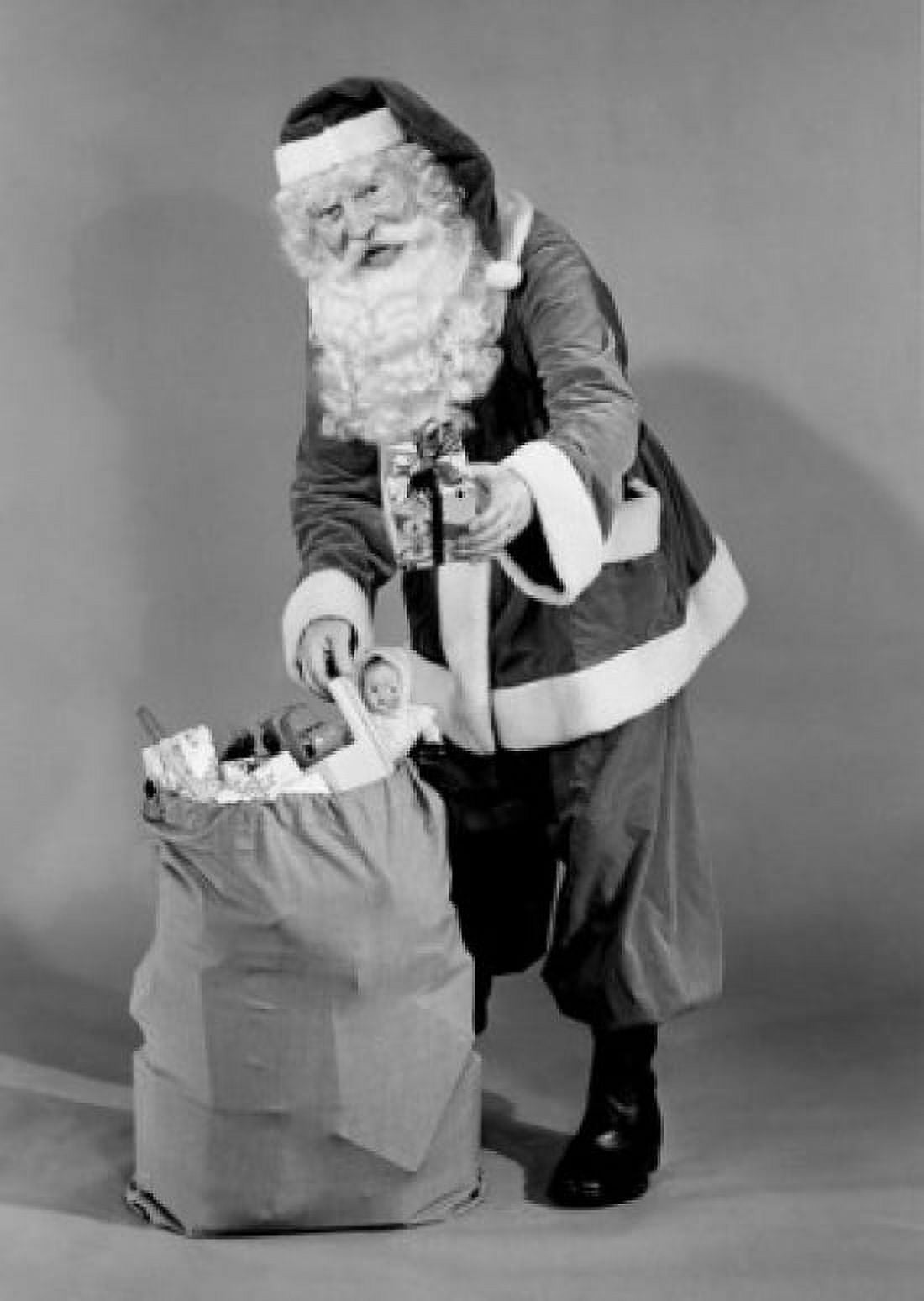 Father christmas pulling present from sack Canvas Art - (18 x 24)