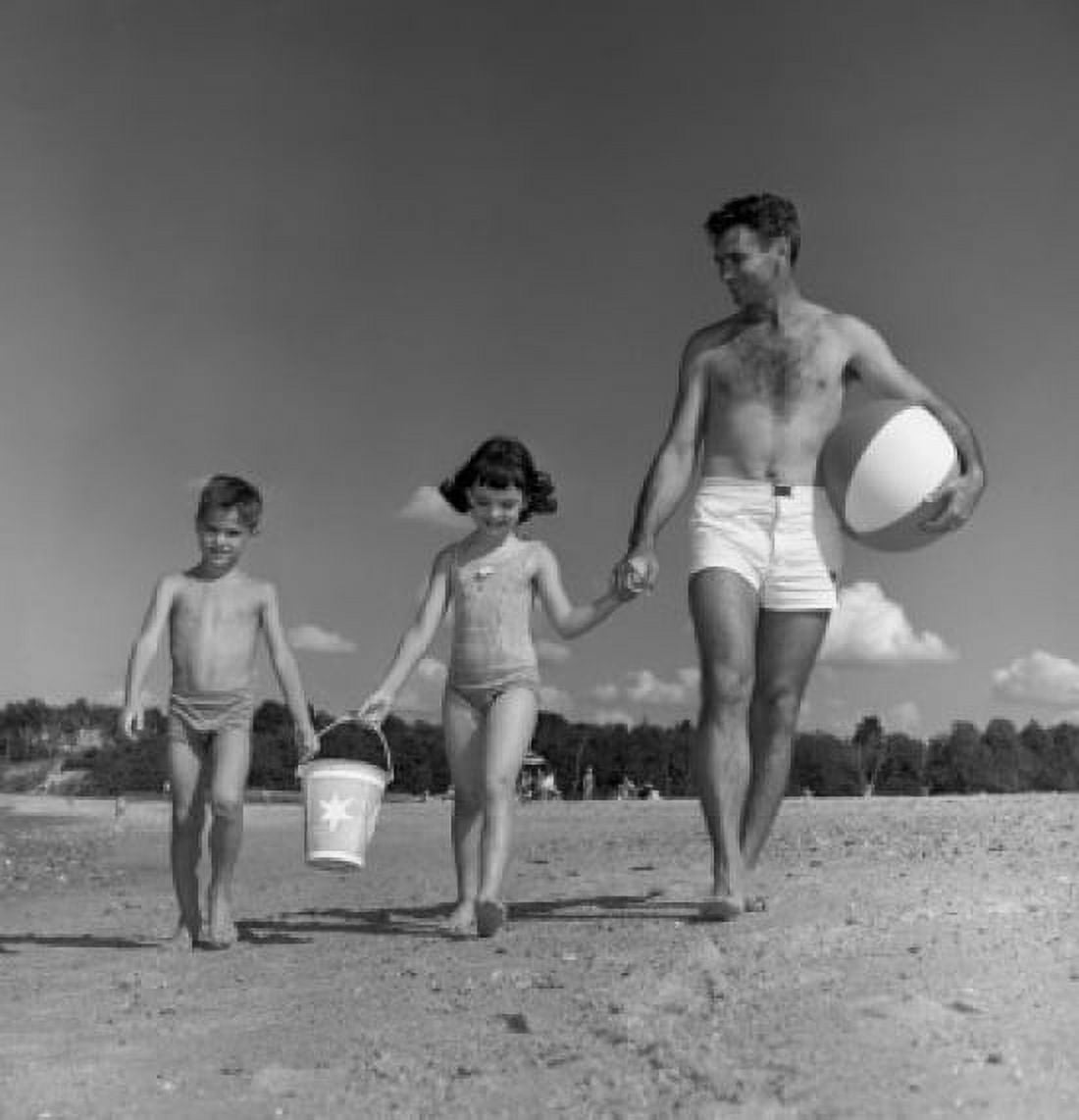 Father daughter and son walking along beach Canvas Art - (24 x 36)