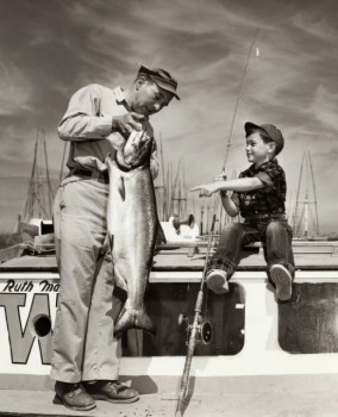 Father holding a fish on a boat with his son Canvas Art - (18 x 24)