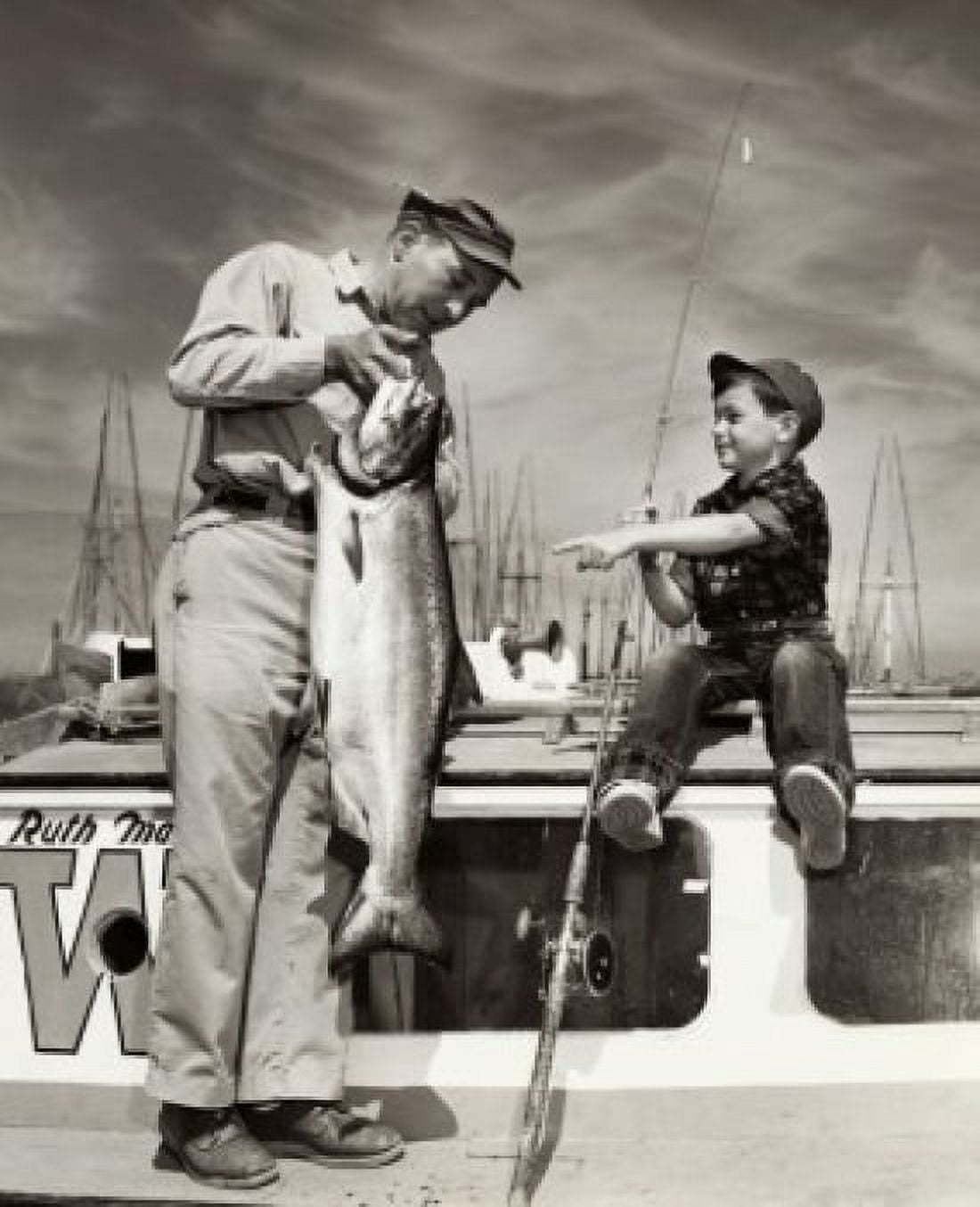 Father holding a fish on a boat with his son Canvas Art - (24 x 36)