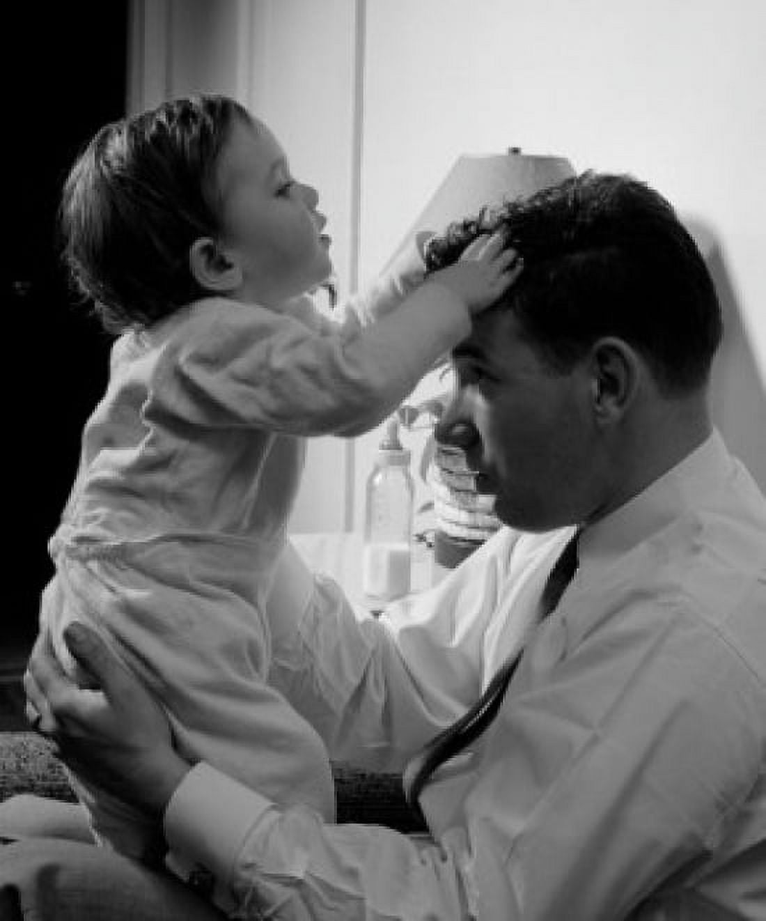 Father holding son in home Canvas Art - (18 x 24)