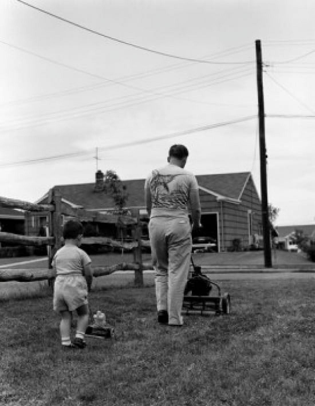 Father mowing lawn with son in back yard Canvas Art - (18 x 24)