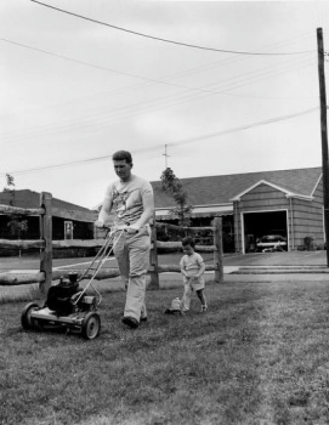 Father mowing lawn with son in back yard Canvas Art - (24 x 36)