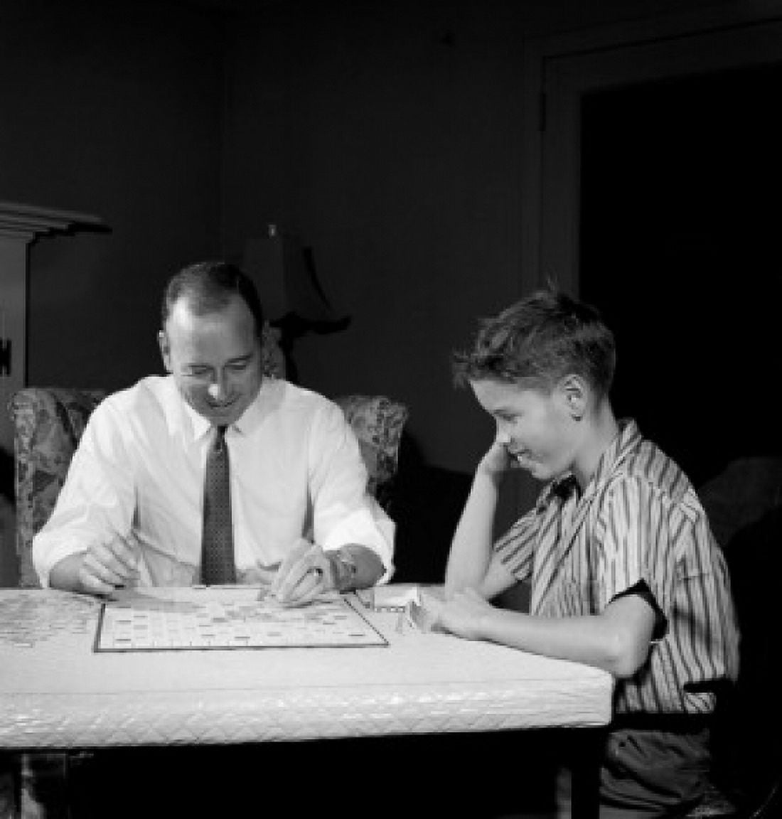 Father playing scrabble with son in home Canvas Art - (18 x 24)