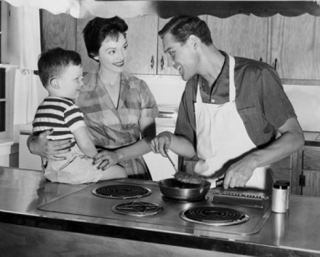 Father preparing food with his wife and son standing beside him in the kitchen Canvas Art - (18 x 24)
