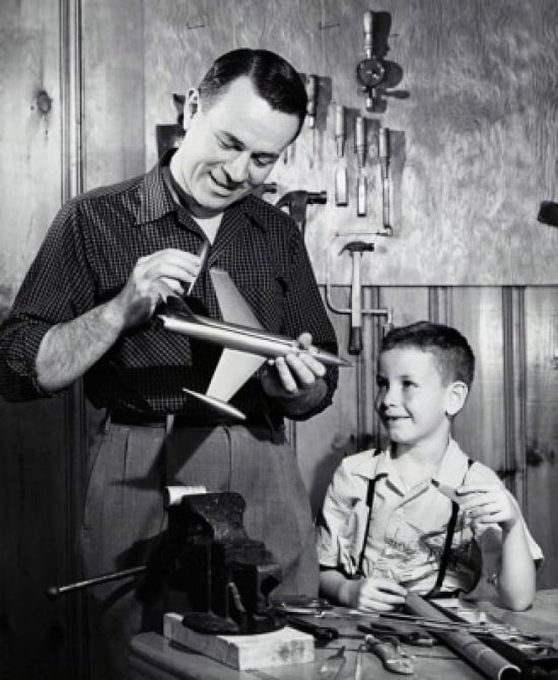 Father repairing a model airplane with his son standing beside him Canvas Art - (18 x 24)