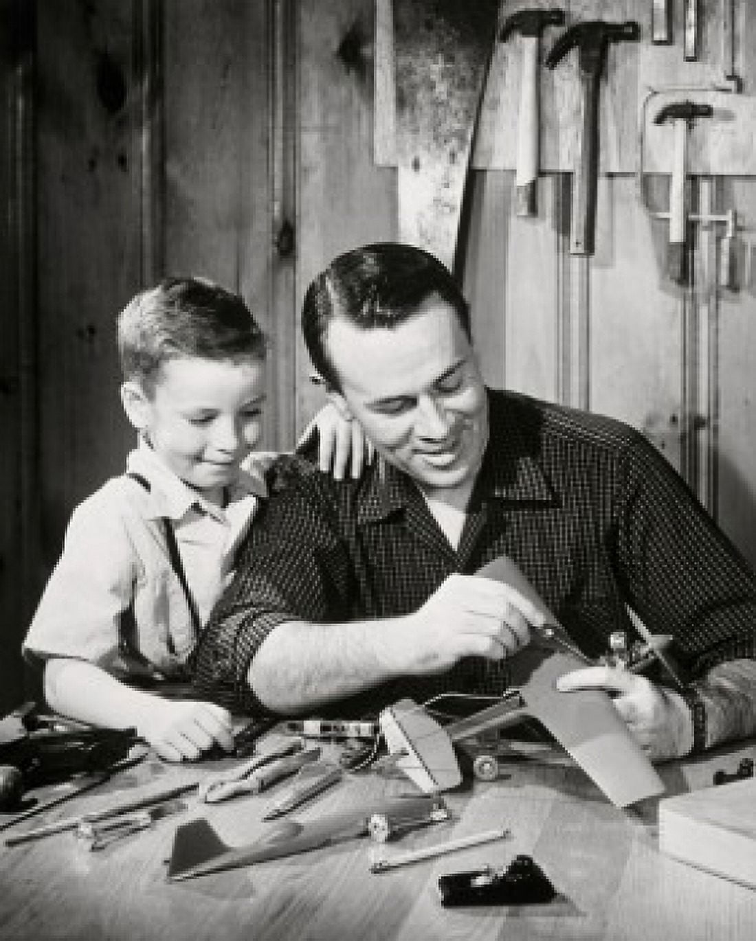 Father repairing model airplane while son standing beside him Canvas Art - (18 x 24)