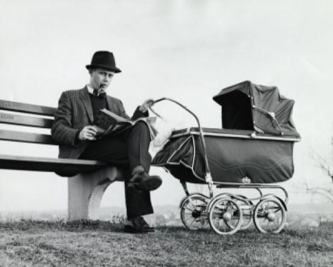 Father sitting on a bench holding a baby carriage Canvas Art - (24 x 36)