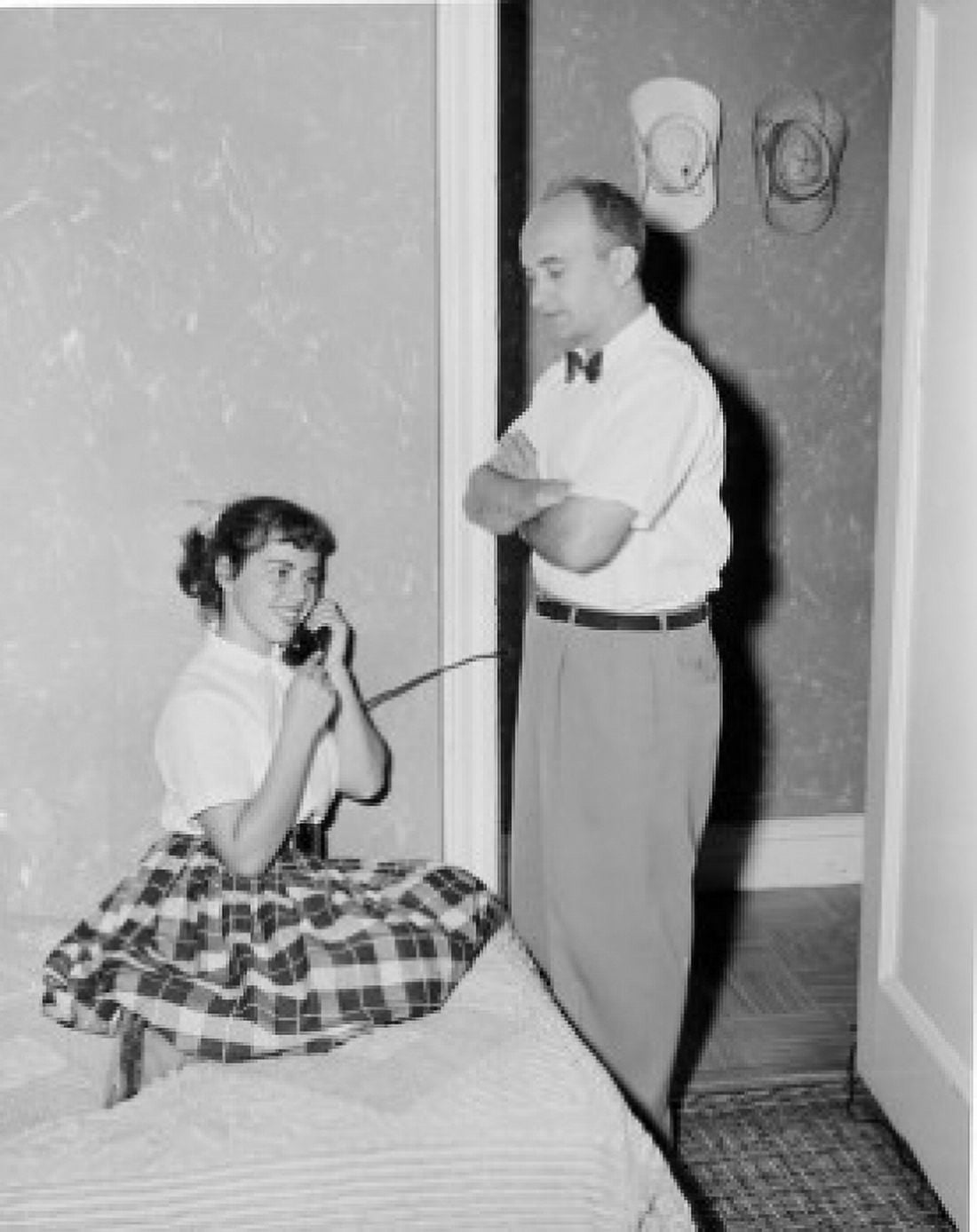 Father watching teenage daughter using telephone in home Canvas Art - (18 x 24)