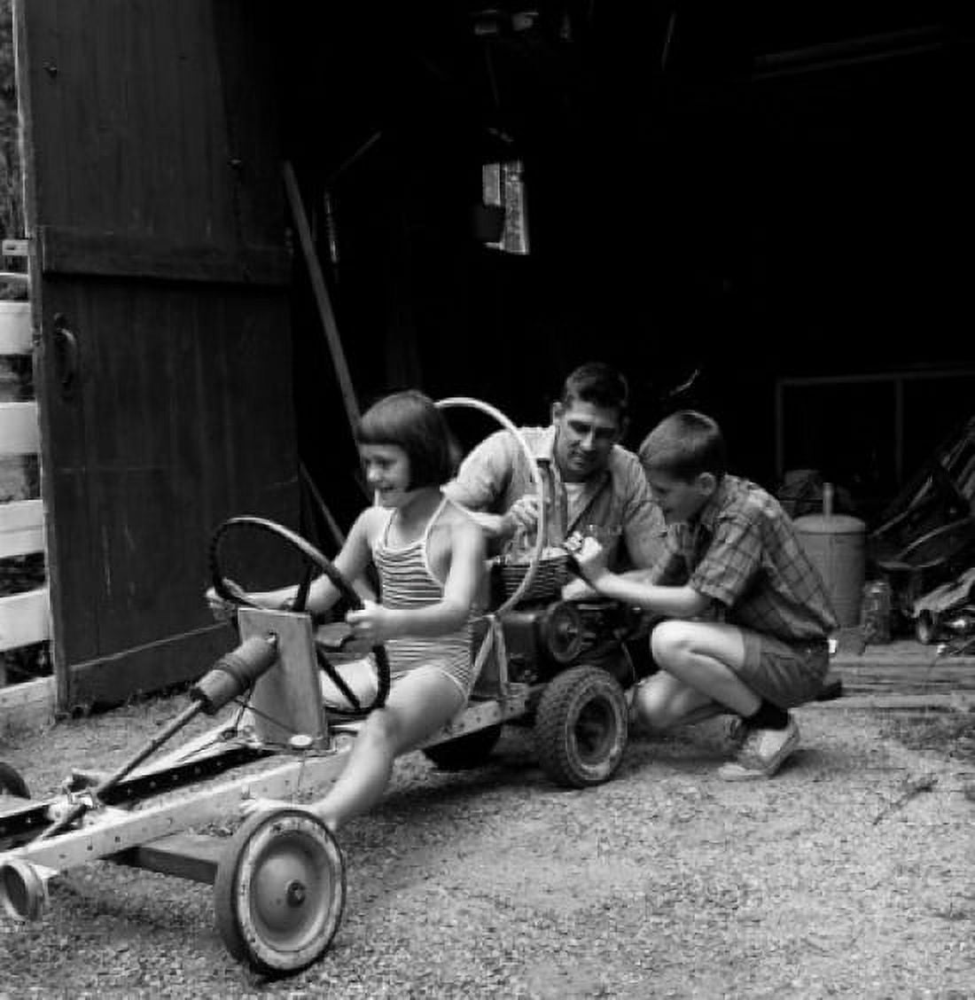 Father with children playing with funny vehicle Canvas Art - (18 x 24)
