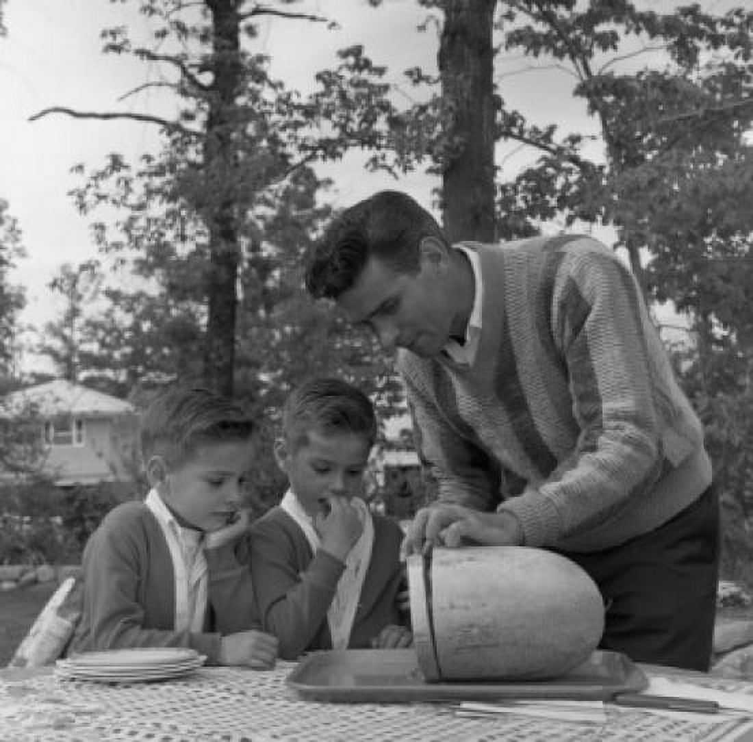 Father with twin sons cutting watermelon Canvas Art - (18 x 24)