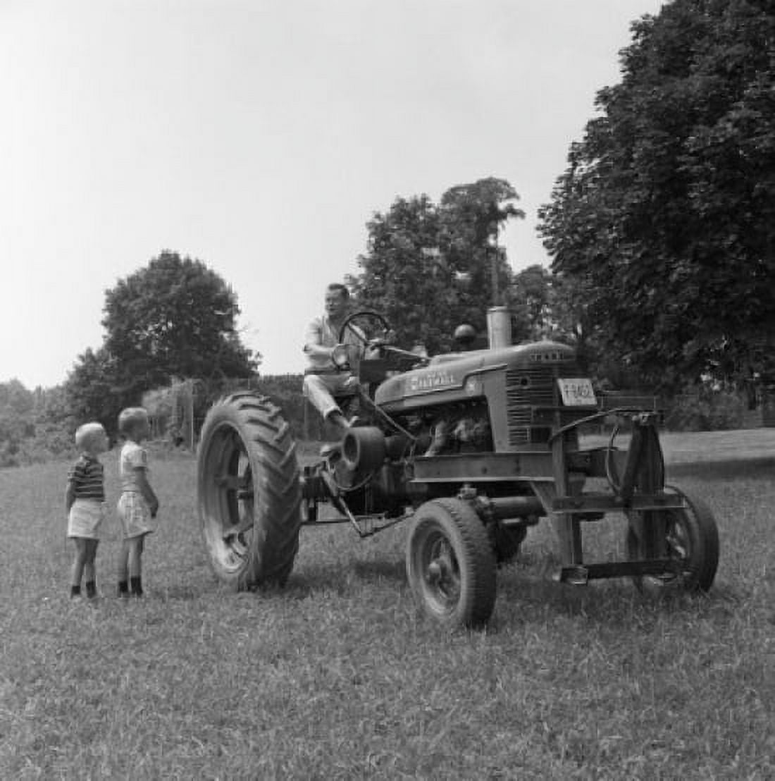 Father with two sons working on field Canvas Art - (24 x 36)
