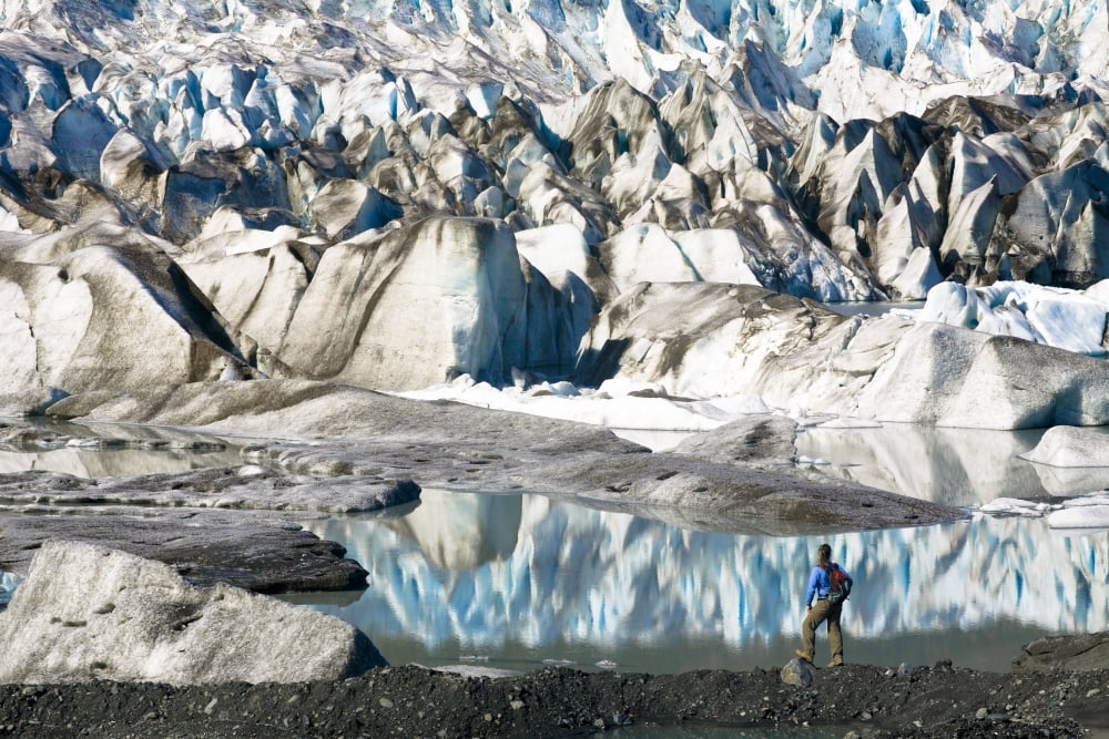Female Hiker Pauses To View Bear Glacier From The Shore Of Bear Glacier Lake In Kenai Fjords National Park Kenai Peninsula Southcentral Alaska Summer Canvas Art - Michael DeYoung Design Pics (34 x 22